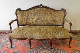 A Victorian carved walnut five piece salon suite comprising settee, a pair of armchairs and matching