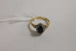 An 18ct gold diamond and sapphire ring. CONDITION REPORT: Good condition.