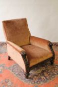 A carved oak framed lounge chair. CONDITION REPORT: Good condition.