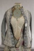 A nineteenth century style embroidered dress on mannequin, height 152 cm. CONDITION REPORT: Some