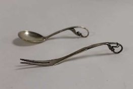 A sterling silver George Jensen spoon, with leaf scroll terminal, together with a two-prong fork