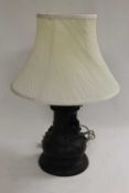 An oriental bronze table lamp decorated with mythical creatures, height36 cm. CONDITION REPORT: Good