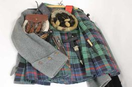 A tartan kilt, together with two tunics, two sporrans, belt and dirks.  CONDITION REPORT: Good