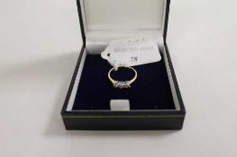 An 18ct gold three stone diamond ring. CONDITION REPORT: Good condition.