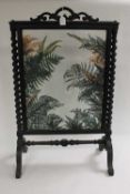 A Victorian glazed fire screen with foliage detail, height 95 cm. CONDITION REPORT: An unusual