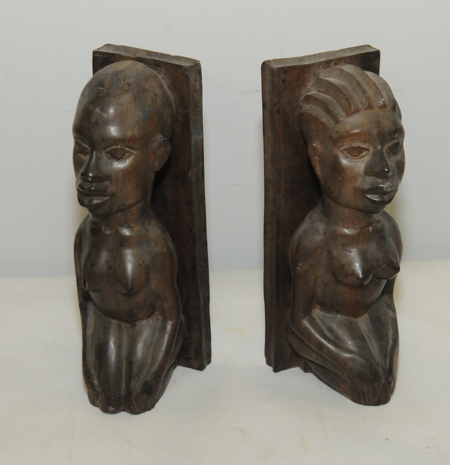 Pair of African carved hardwood bookends of female figural form, each 9½" high.  (2).