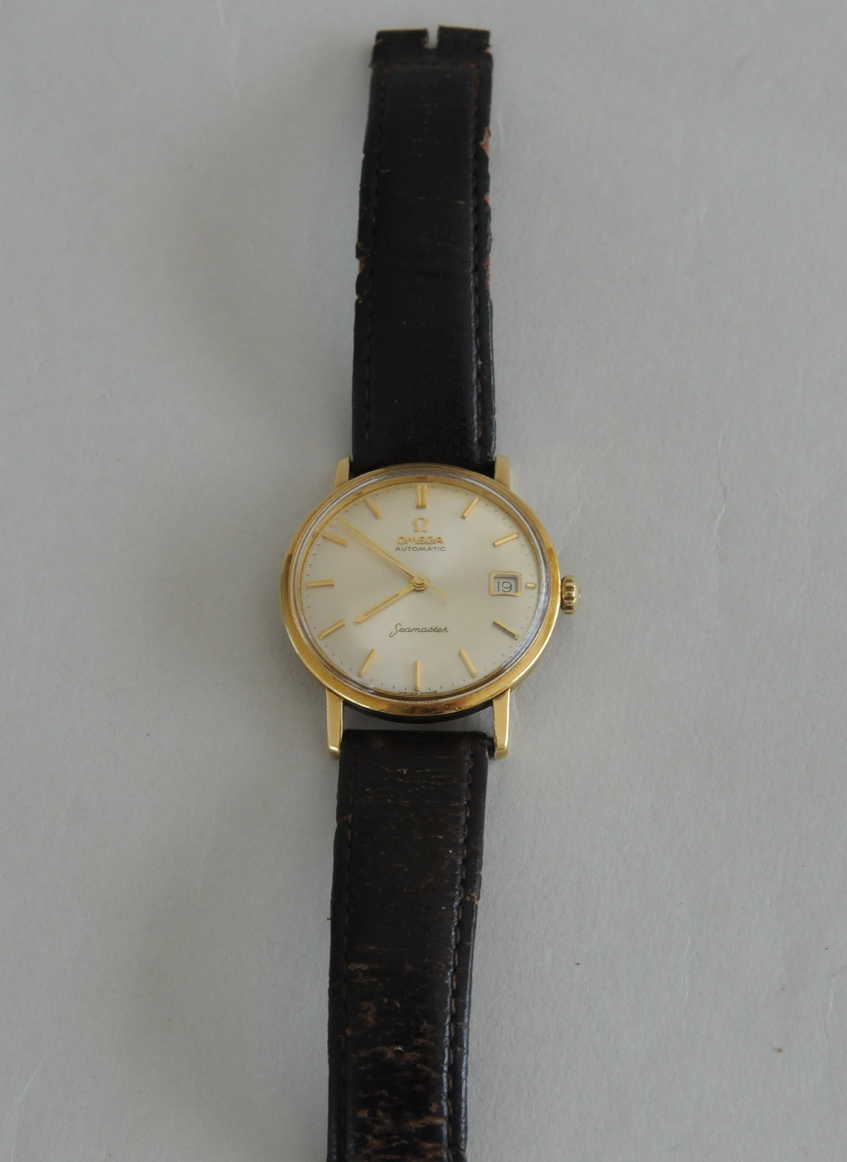 Gent's Omega Seamaster 9ct gold watch, on strap.