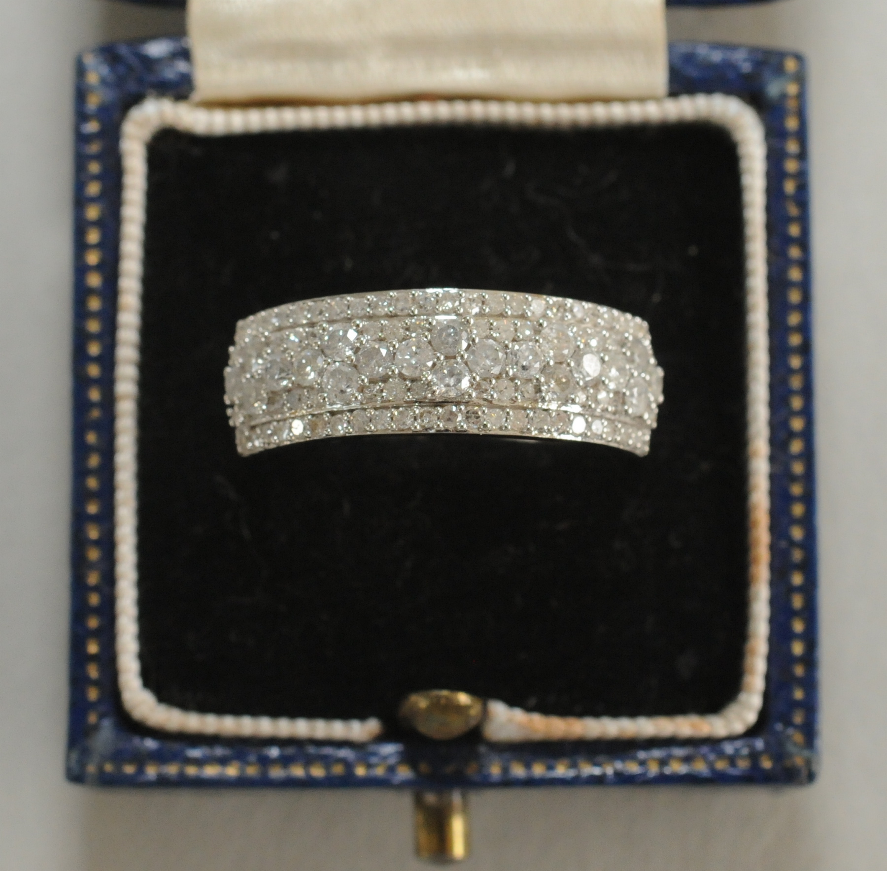 Diamond ring with four rows of pavé set mixed cut brilliants, pavé set in 9ct gold.