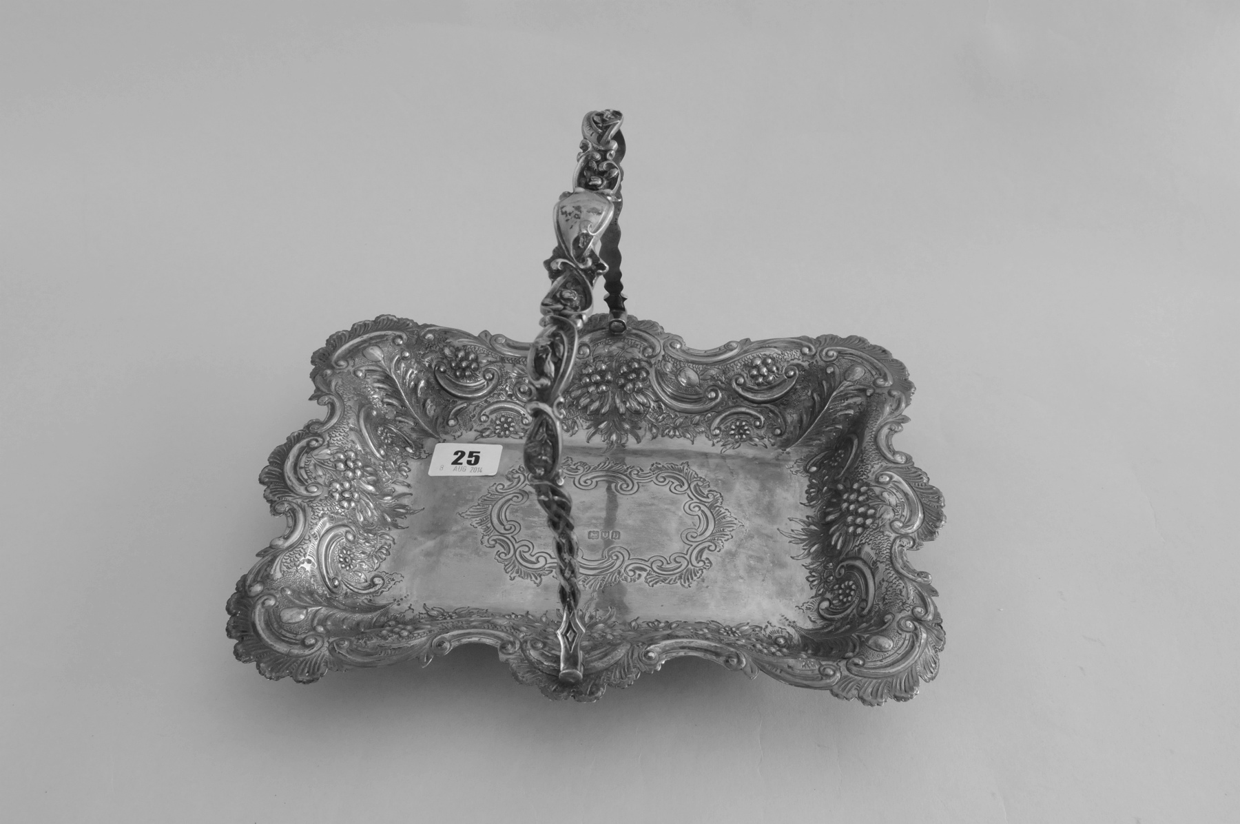 Silver rectangular cake basket, embossed, with waved edge on bun feet, by Huttons, 1897, 17 oz.