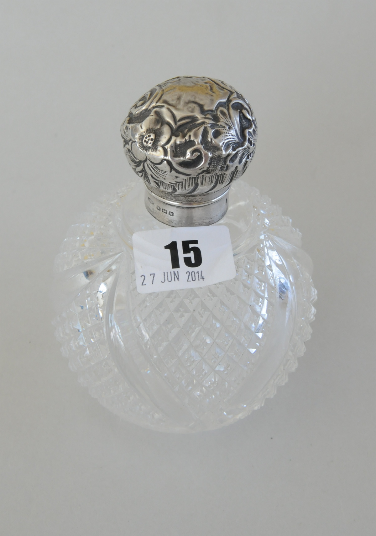 Cut glass scent bottle, hemispherical with embossed silver mounts, Birmingham, 1909.