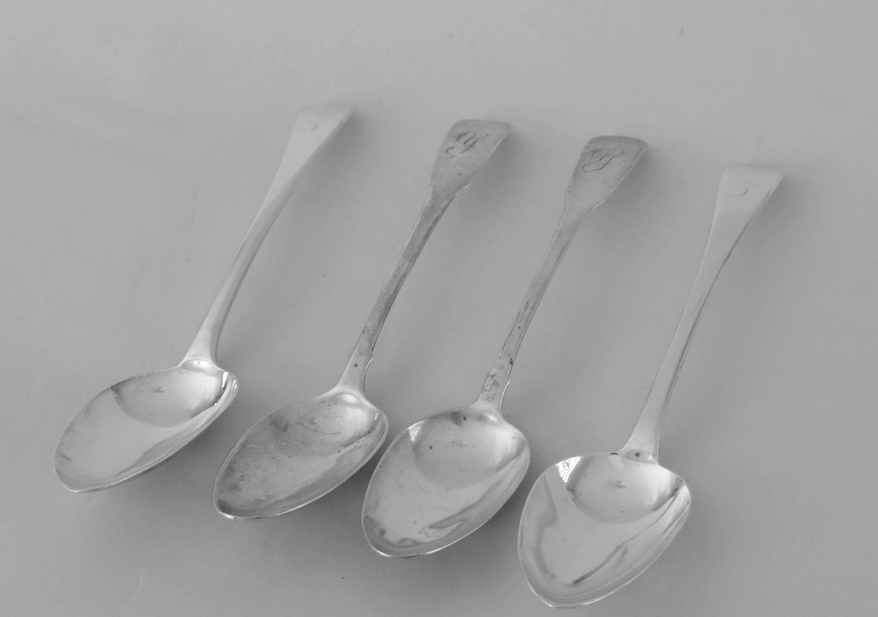 Pair of silver table spoons initialled 'T', by Robert Rutland, 1823 & another two, fiddle pattern,