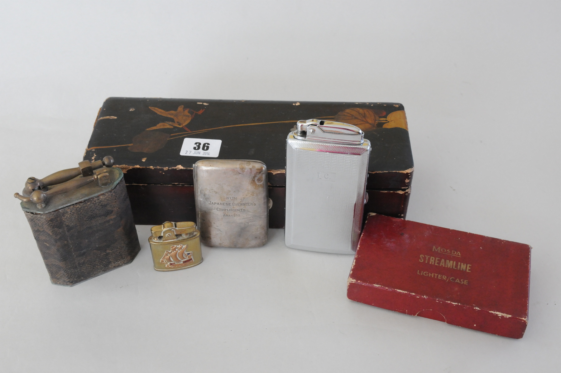 Silver cigarette case 'With Japanese Overseer's compliments Xmas 1911' & three lighters, in alacquer