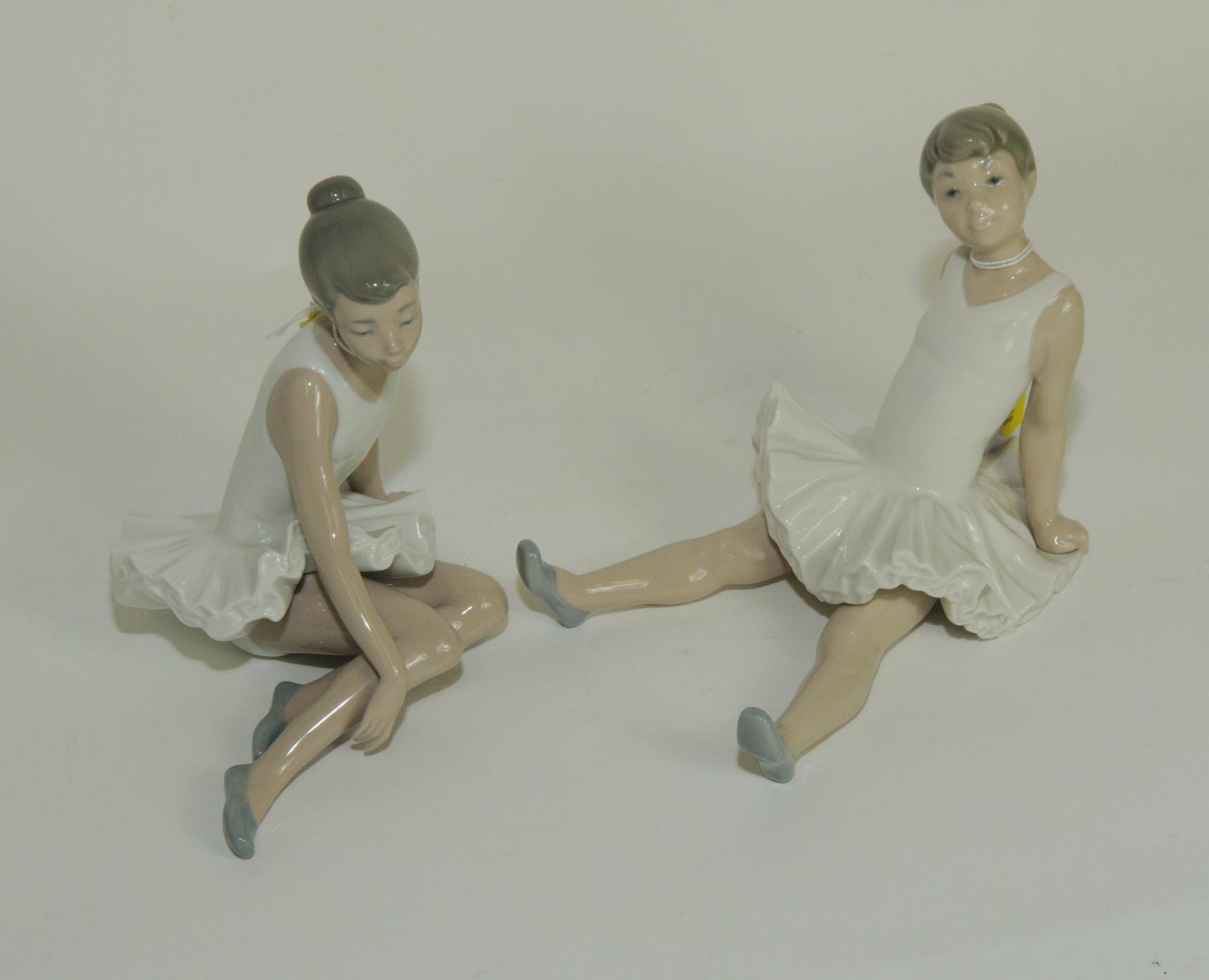 Two Nao porcelain figures of young ballerinas sitting down, each 6" high.  (2).