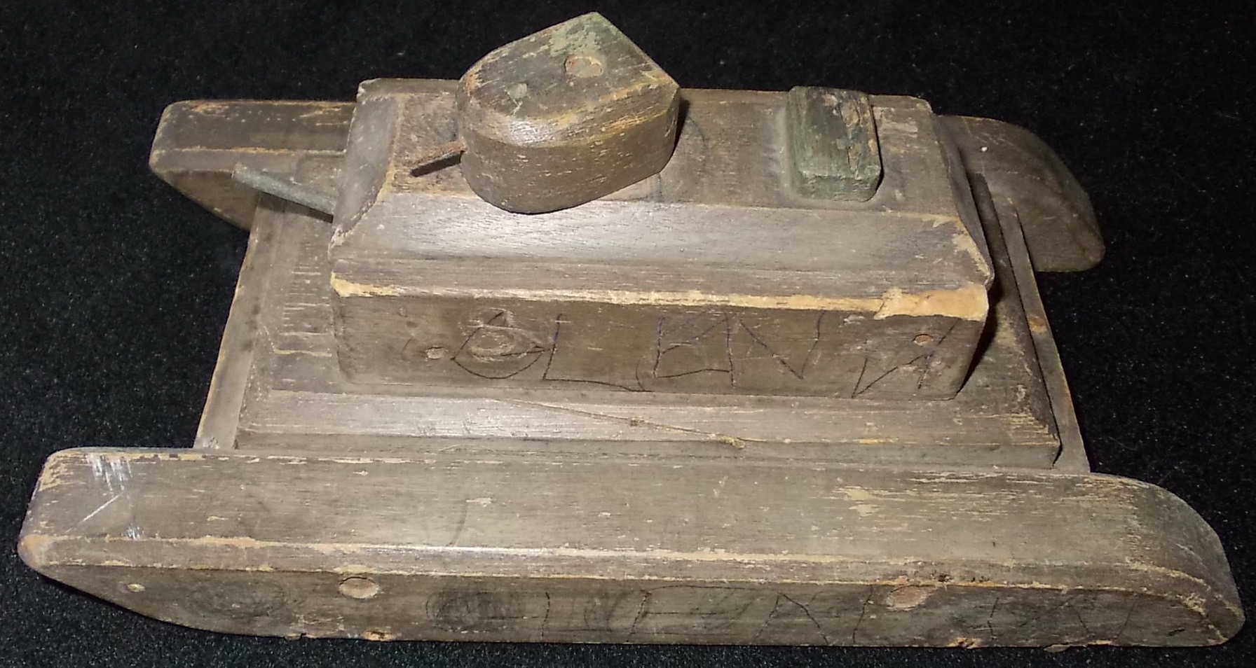 Wooden tank. Wheeled, 10 in. long. Possibly for training purposes. Also 3 small metal cannon.