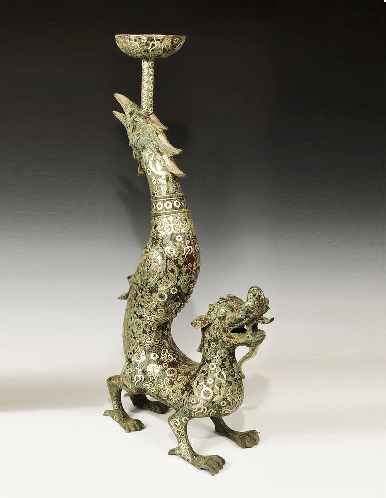 Chinese Style Bronze Dragon Candlestick with Silver InlayA undated archaistic hollow-cast