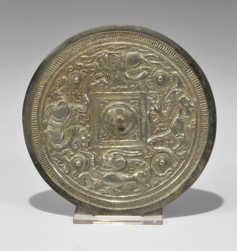 Chinese Style Bronze Figural MirrorHan Dynasty, 206 BC-220 AD. A small cast-bronze disc mirror