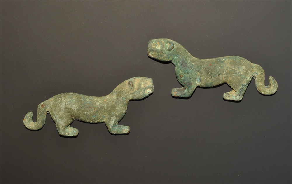 Near Eastern Bronze Lion Appliqué PairA matched pair of undated archaistic cast lion mounts, each