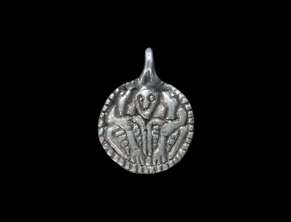 Scandinavian Viking Silver Pendant with Odin Gripping Two Ravens9th-10th century AD. A cast