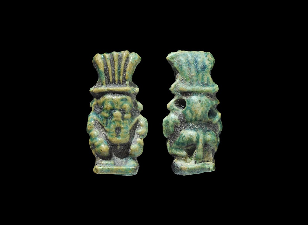 Egyptian Glazed Composition Bes AmuletLate Period, 664-332 BC. A deep green amuletic pendant of