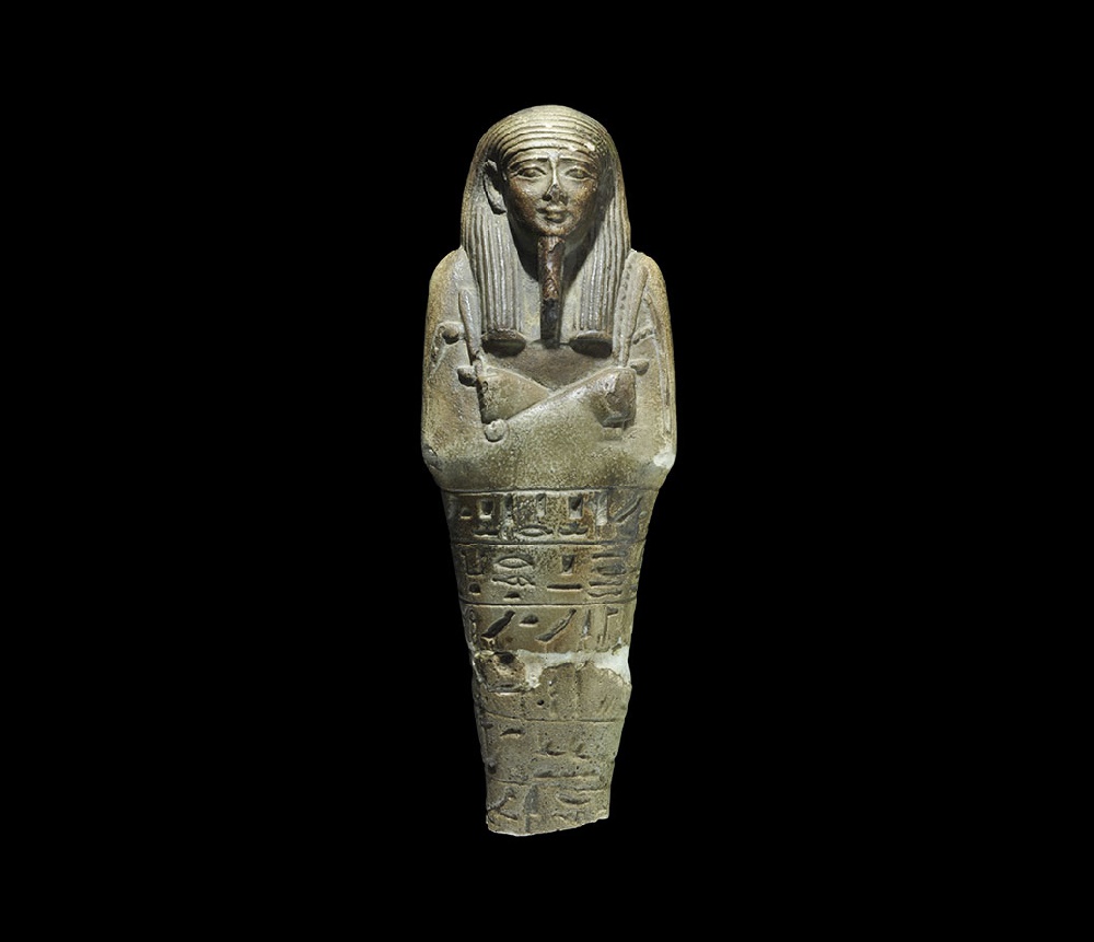 Egyptian Glazed Composition Hieroglyphic ShabtiSaite Period, 624-525 BC. An olive-green shabti