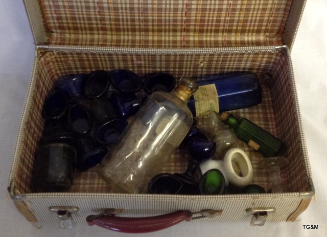 collection of glass eye baths and medicine bottles