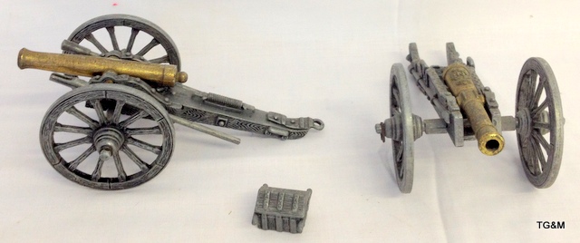 Two brass and white metal cannons