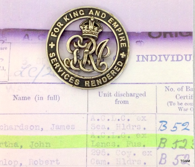 A WW1 Silver War Badge for Services Rendered numbered B52380 with a copy of the Badge Roll showing