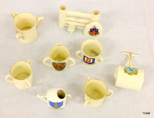 Eight pieces of crested china to include a watering can and a garden roller