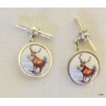 a pair of Silver and enamel cufflinks depicting a stag