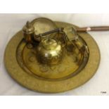 A large brass embossed salver, brass kettle and other brassware