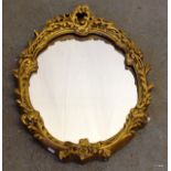 An oval gilded mirror 48 x 65 cm