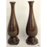 Pair of oriental elongated bronze vases with silver inlaid decoration.  30cm high