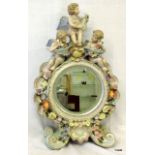 A Porcelain cherub and flower mantle mirror 55cm high 36cm wide