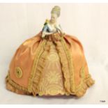 A Victorian German porcelain bodied door stop in original Victorian silk and lace dress wear, 26cm