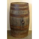 A full size oak beer barrel with steel banding 89cm high