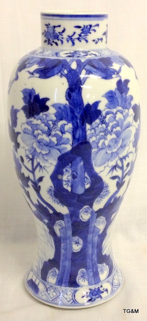 C19th Chinese blue and white vase with peony and foliate decoration.  26cm high