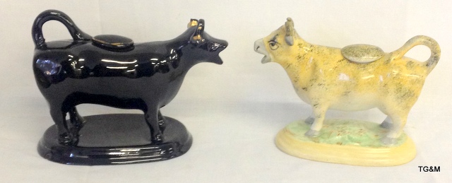 A Pair of pottery cow creamers