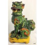 Chinese Tang figure of seated Fo dog with sancai glaze