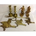 An assortment of brass wear candlesticks 3 brass ducks and 2 figurines, toasting fork and military