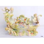 A Sitzendorf porcelain centrepiece surmounted with cherubs and birds 22x29cm