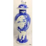 C19th Chinese blue and white baulster vase with lid, figures in panels on prunus background.  28cm