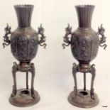 Pair of Japanese bronze vases on tripod bases with dragon handles.  31cm high