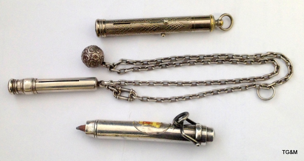 Three propelling pencils, silver and other