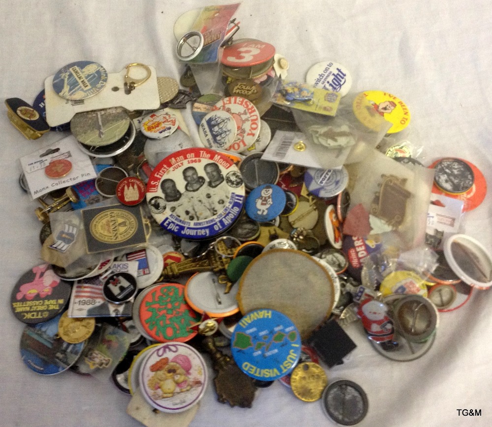 Collection of metal badges including Apollo Moon Landing