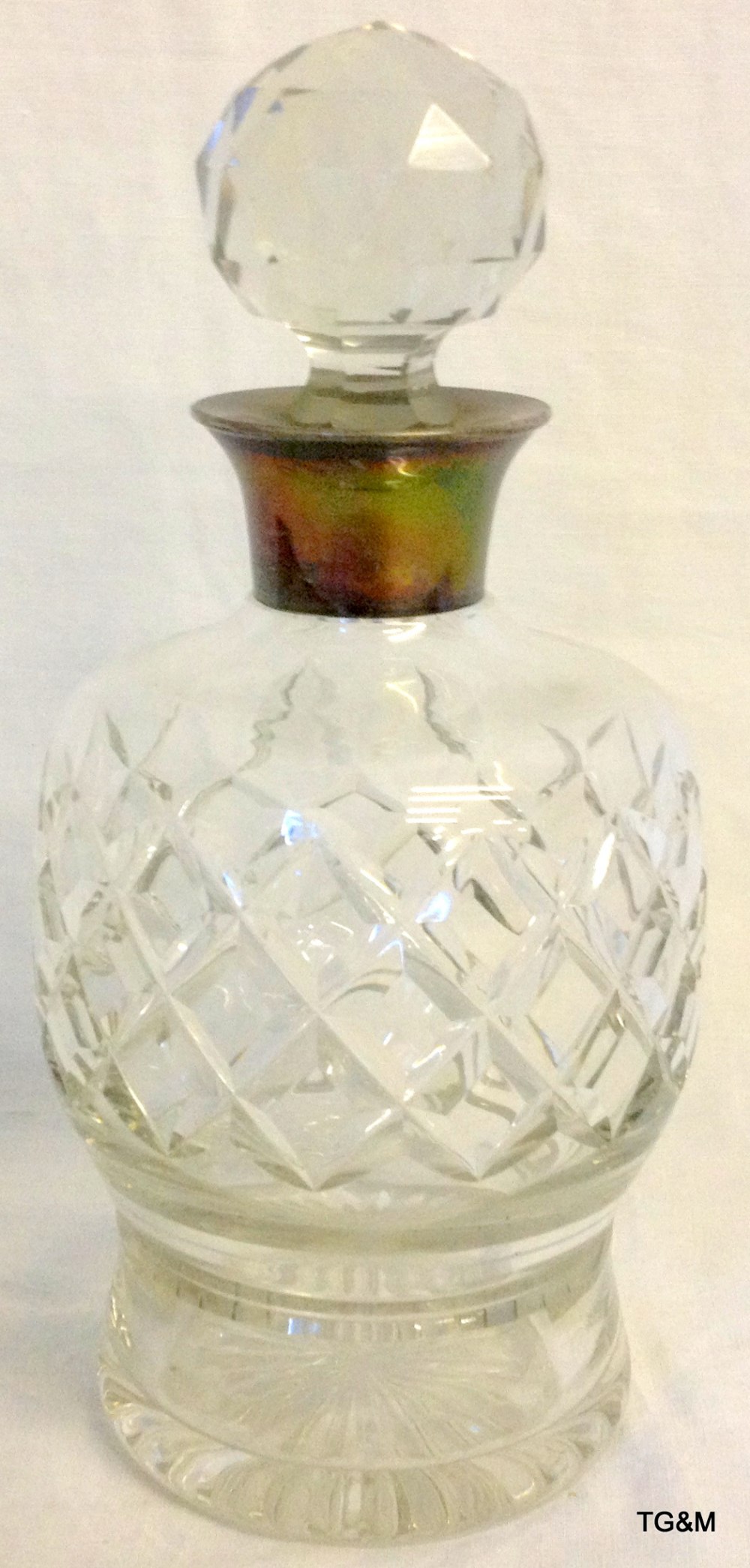 Cut glass decanter with silver mount