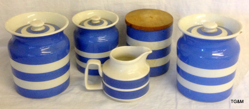 Four T G Green storage jars and a jug