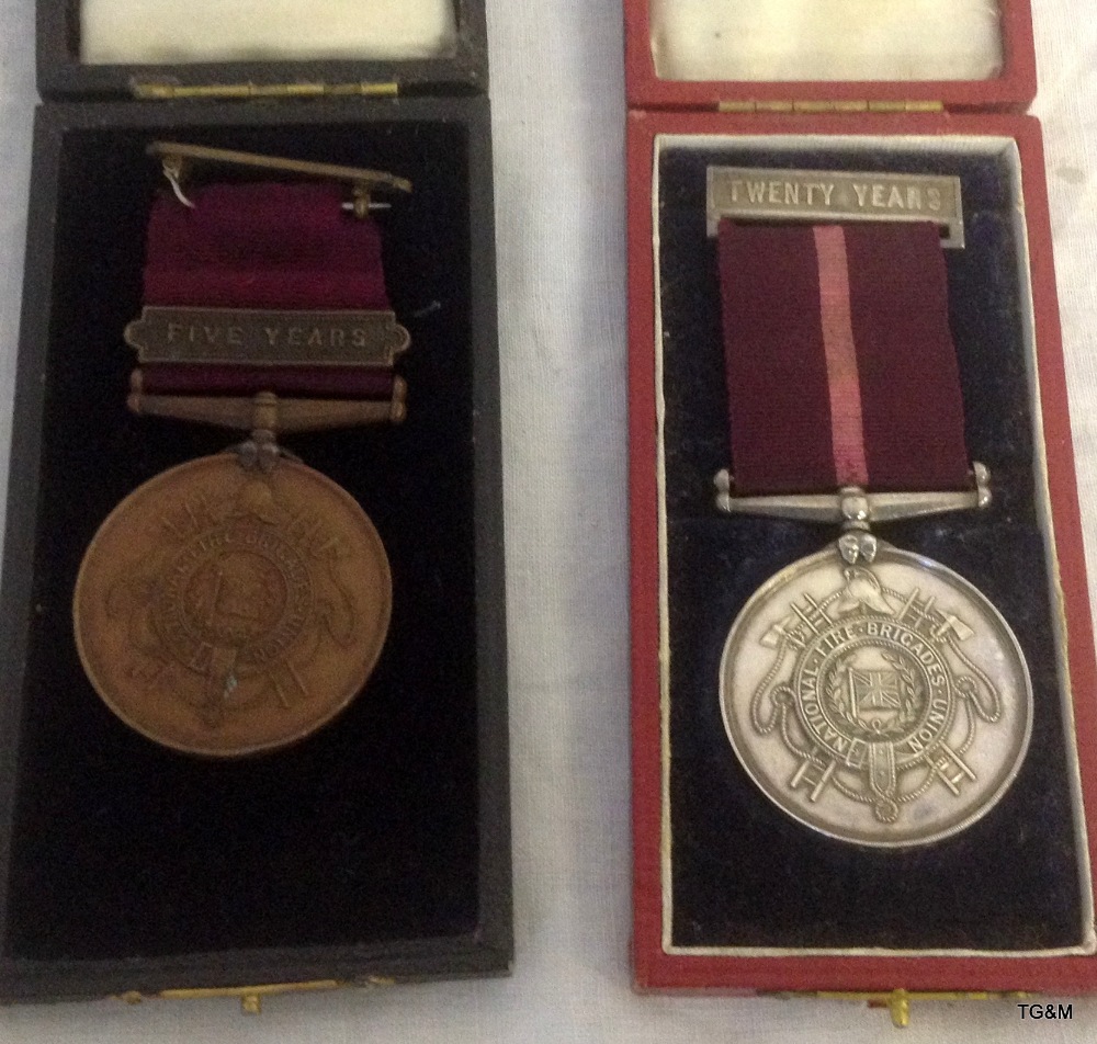 A pair of rare early 20th century National Fire Brigades Long Service Medals, one in silver the