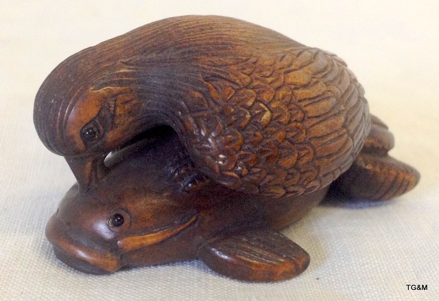 Detailed carved wooden sea eagle catching a fish