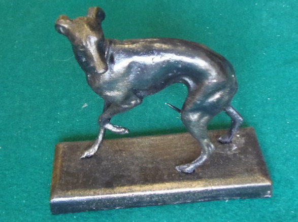 A small greyhound figure