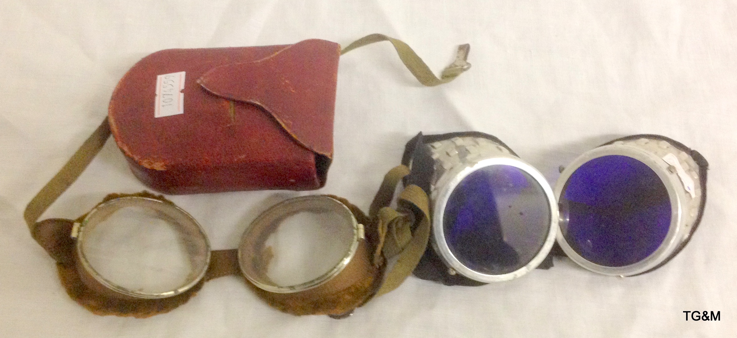 Two pairs of vintage goggles, one with case